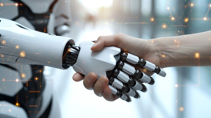 A human and a robot are shaking hands.