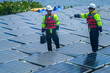 Engineers in safety gear inspect solar panels at a renewable energy farm, ensuring sustainable power efficiency