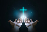 Fototapeta Na sufit - Easter concept, Open hands  holding a glowing cross , symbol of Christian faith.