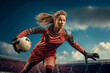 A womens soccer football goalkeeper diving to save the ball in a dramatic action shot in saving the cross or penalty and denying the goal being scored in a dynamic stadium