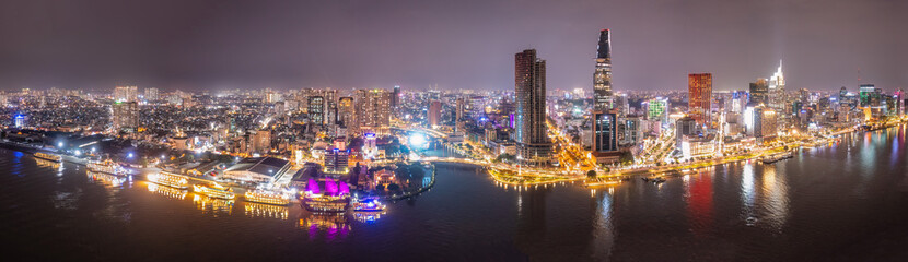 Wall Mural - Aerial panoramic cityscape view of HoChiMinh city and the River Saigon, Vietnam with blue sky at sunset. View from Thu Thiem peninsula