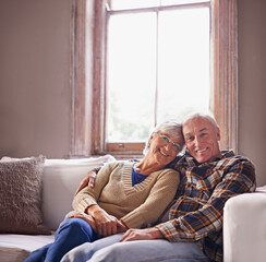 Poster - Elderly couple, smile and portrait on sofa for family, retired and relax for break or rest on mockup. Pensioners and hugging with happiness for embrace, love and comfort on couch in house for unwind