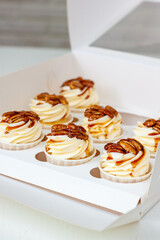 Wall Mural - Pumpkin spice caramel pecan cupcakes with cream cheese frosting