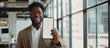 Business App. Black Young Businessman Holding Big Blank Smartphone In Hand, Smiling Male African American Entrepreneur Demonstrating White Phone Screen, Recommending Mobile Application, Mockup