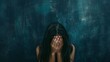 Woman hiding face against a dark backdrop. Visual representation of sorrow and emotional pain. Artistic expression of personal distress in a somber setting.
