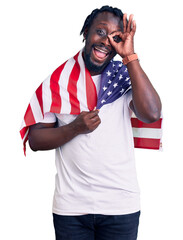 Poster - Young african american man with braids wearing united states flag smiling happy doing ok sign with hand on eye looking through fingers