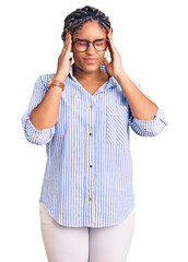 Canvas Print - Young african american woman with braids wearing casual clothes and glasses with hand on head for pain in head because stress. suffering migraine.