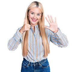 Poster - Beautiful blonde woman wearing casual striped shirt showing and pointing up with fingers number six while smiling confident and happy.