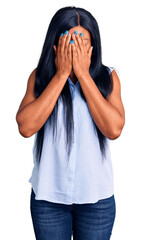 Wall Mural - Young african american woman wearing casual clothes with sad expression covering face with hands while crying. depression concept.