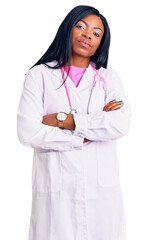 Poster - Young african american woman wearing doctor stethoscope looking to the side with arms crossed convinced and confident