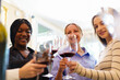 © DG PhotoStock - Group of diverse ethnicity people enjoy testing red wine together.