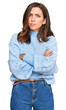 © Krakenimages.com - Young brunette woman wearing casual winter sweater skeptic and nervous, disapproving expression on face with crossed arms. negative person.