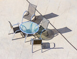 Fototapeta  - Shadow on the floor from a glass table with chairs