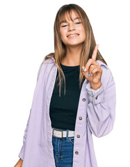 Wall Mural - Teenager caucasian girl wearing casual clothes showing and pointing up with finger number one while smiling confident and happy.