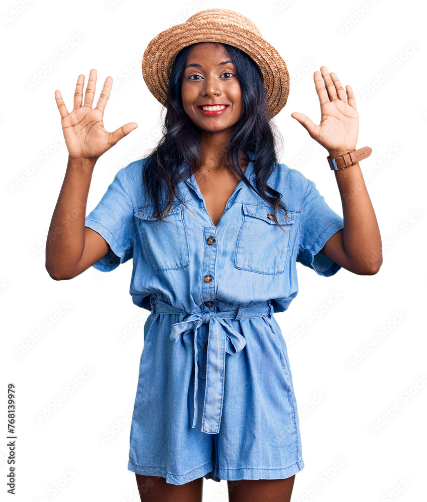Young indian girl wearing summer hat showing and pointing up with fingers number ten while smiling confident and happy.