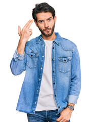 Poster - Young hispanic man wearing casual clothes shooting and killing oneself pointing hand and fingers to head like gun, suicide gesture.