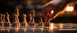 close up of a hand moving a chess piece across a board, with a blurred background