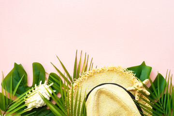 Wall Mural - Summer composition flat lay. Palm leaves, sea shells, hat and sunglasses on pink background.