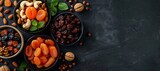 Fototapeta  - A top view of an fruits assortment of dried fruits including dates, prunes, apricots, raisins, and a variety of nuts, placed in separate bowls, presenting a selection of Ramadan & special event foods
