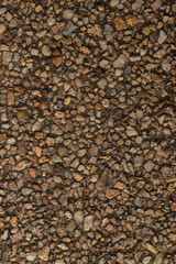 Wall Mural - Vertical blank concrete brown rough wall for background. Beautiful brown exposed aggregate wall plastered surface background pattern.