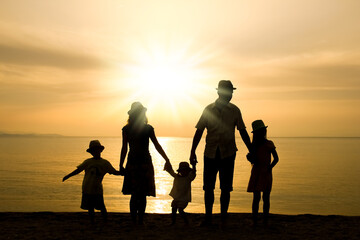 Canvas Print - A happy family in nature by the sea on a trip silhouette