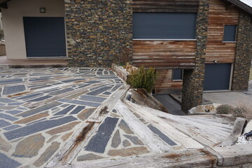 Wall Mural - closeup of a stone terrace and stairs by a stone house