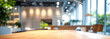 © Галя Дорожинська - A wooden table positioned in a professional office environment with a blurred background. Generative AI