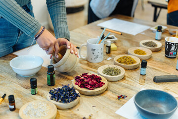 natural soap workshop. grinding ingredients with a pestle and bowl