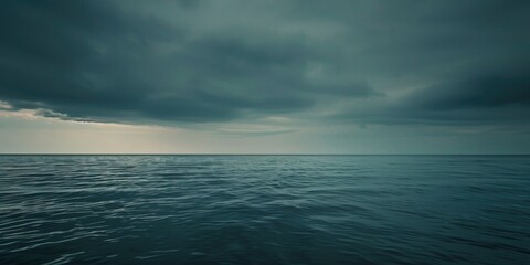 a large body of water reflects the dramatic grey sky above