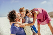 © Marko Geber - Family together on sandy beach during daytime