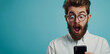 Shocking News: Surprised man with glasses stares at his smartphone, mouth open in amazement