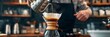 Barista brews drip brewing in a pour-over, close-up of a pour-over with hot water and filter paper, filtered coffee or pour over coffee, banner