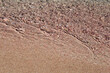 Wave on pink sand beach, background
