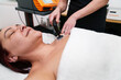 Patient relaxes during a soothing electrotherapy treatment on neck.