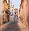 Narrow street with old buildings with colorful facades in the ancient part of Alicante in Costa Blanca