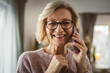 © Miljan Živković - One mature blonde woman stand at home use mobile phone talk