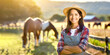 Frau im Vordergrund im Hintergrund Pferde auf einer Wiese 