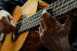 a musician's fingers plucking the strings of a classical guitar, capturing the graceful movement and precise technique of their performance