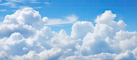 Wall Mural - a group of fluffy white cumulus clouds floating in the electric blue sky, creating a beautiful natur