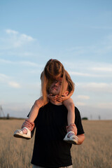 Wall Mural - Daughter sits on her father's shoulders	