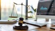 The intersection of law and technology is depicted through a gavel placed on a computer, alongside justice scales in a lawyer's office