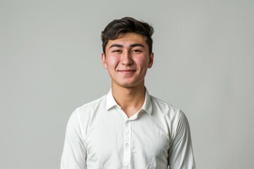 Wall Mural - A young man is smiling and wearing a white shirt