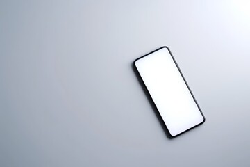 Poster - A modern smartphone with a blank screen laying on a smooth grey surface, depicting connectivity and technology