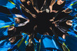 © PoppyPix - low angle view of football player girls standing in a circle and holding hands up before a match. High quality photo
