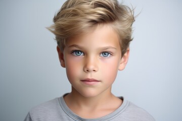 Portrait of a cute little boy with blond hair and blue eyes