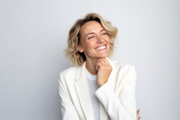 Wall Mural - business, people and office concept - smiling businesswoman in white jacket over grey background