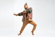 Full length gay man wearing stylish clothing dancing isolated on white. Brazilian homosexual male posing in photo studio. Bearded afro-american gay man cut out on white.