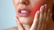 © Ruslan Batiuk - A woman holds her cheek while suffering from a toothache, depicting the discomfort and pain experienced during dental issues, emphasizing the need for oral health care and treatment