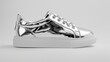 Sleek and modern sneakers in metallic silver, standing out against a clean white surface, reflecting urban style.