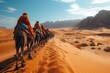 A caravan of camels trekking through the desert under the vast sky and fluffy clouds. These working animals are carrying packs through the aeolian landscape, crossing hills on their travel adventure